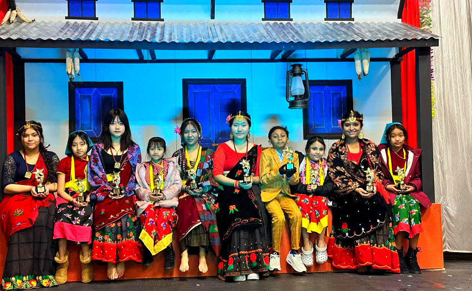 Group of dancers sitting infront of the house