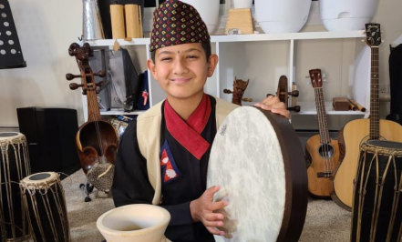 a boy playing a drum