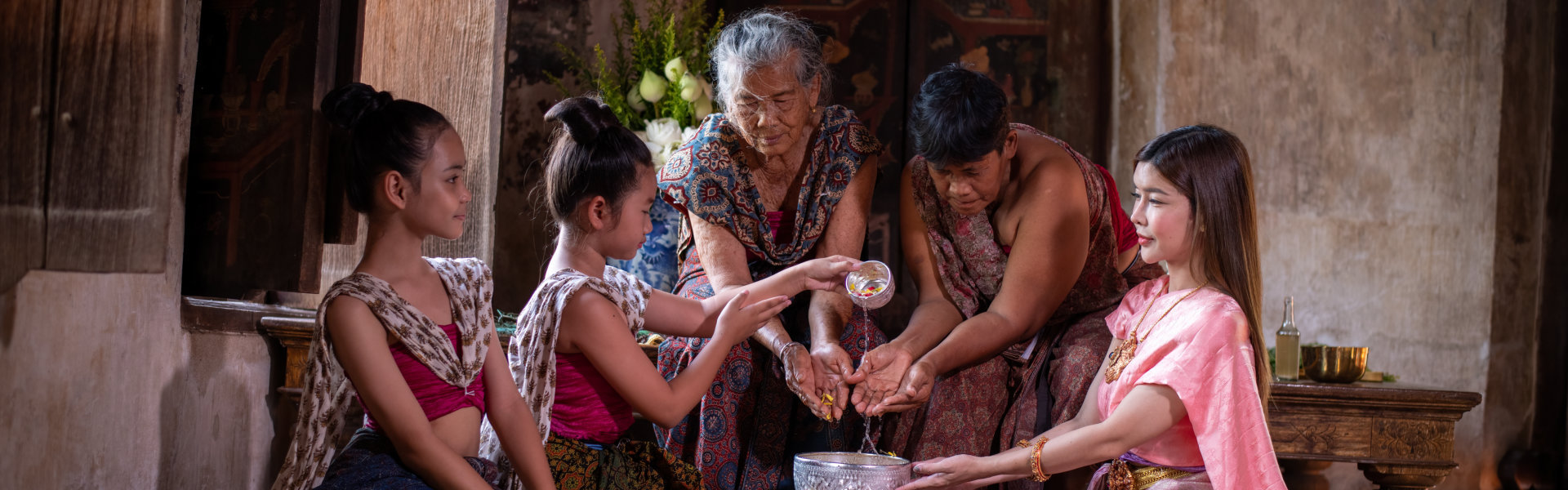 family pour water on the hands of revered elders